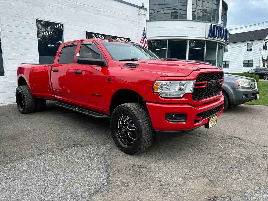 Red Ram dually parked in front of the shop