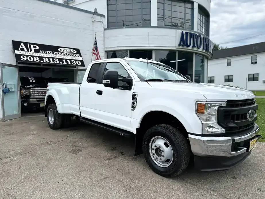 White Ford dually parked by the Auto Perfection sign, out front on High Street