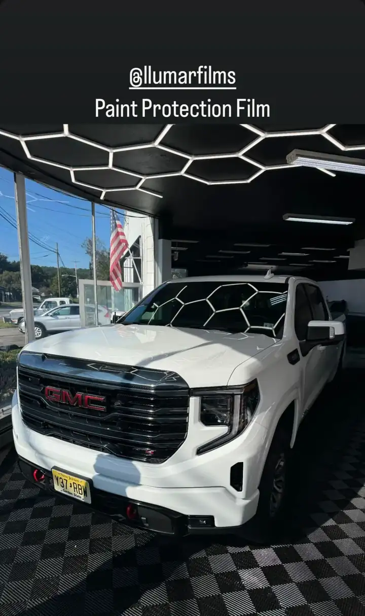 White GMC truck in the hex-lit bay after film