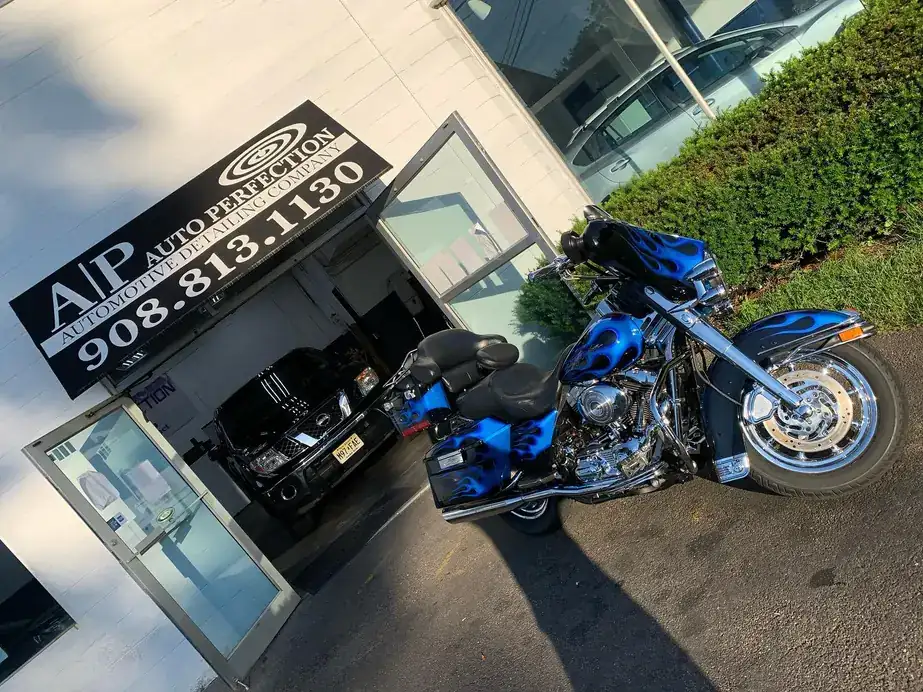 Blue Harley-Davidson parked at the AP awning